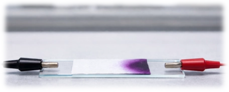 Potassium manganate(VII) ion migration towards the positive electrode